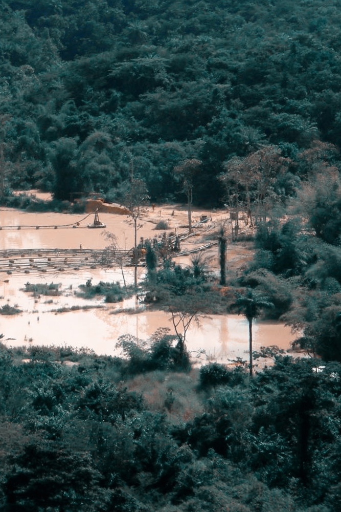 An image showing a clearing in the rainforest for illegal diamond mining.